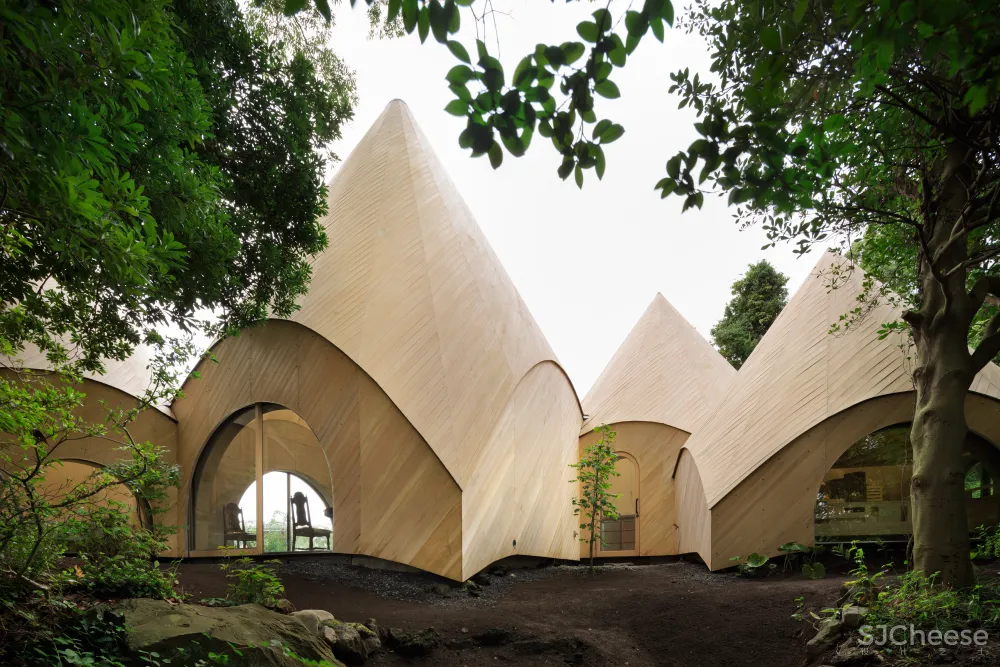 Teepee-shaped buildings by Issei Suma house community kitchen and pool