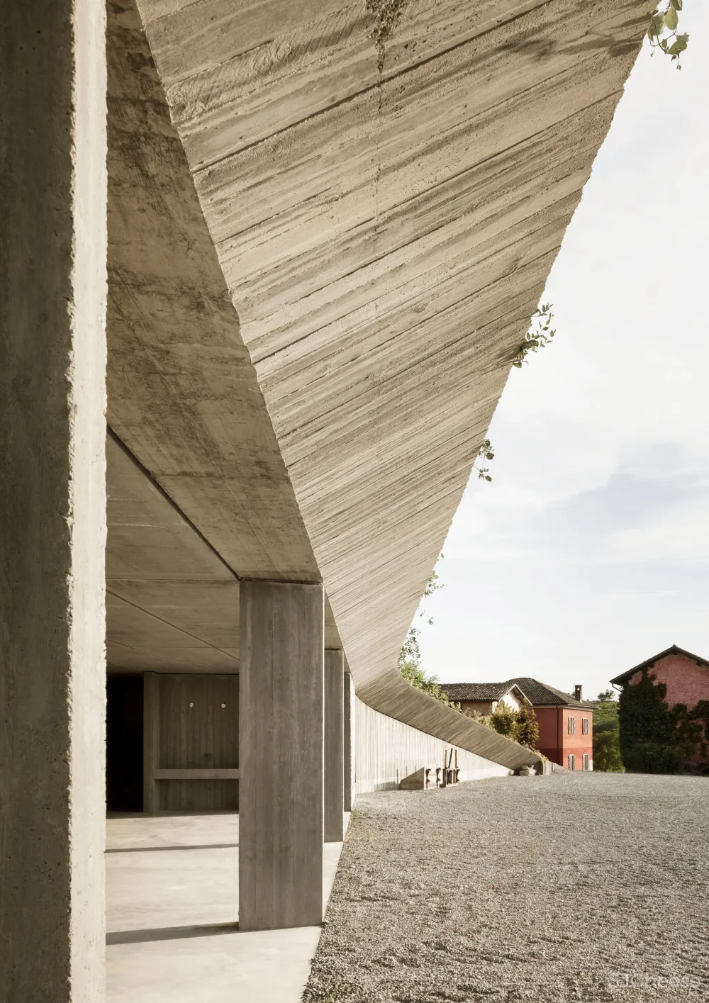 Deamicisarchitetti submerges concrete machinery depot into hillside