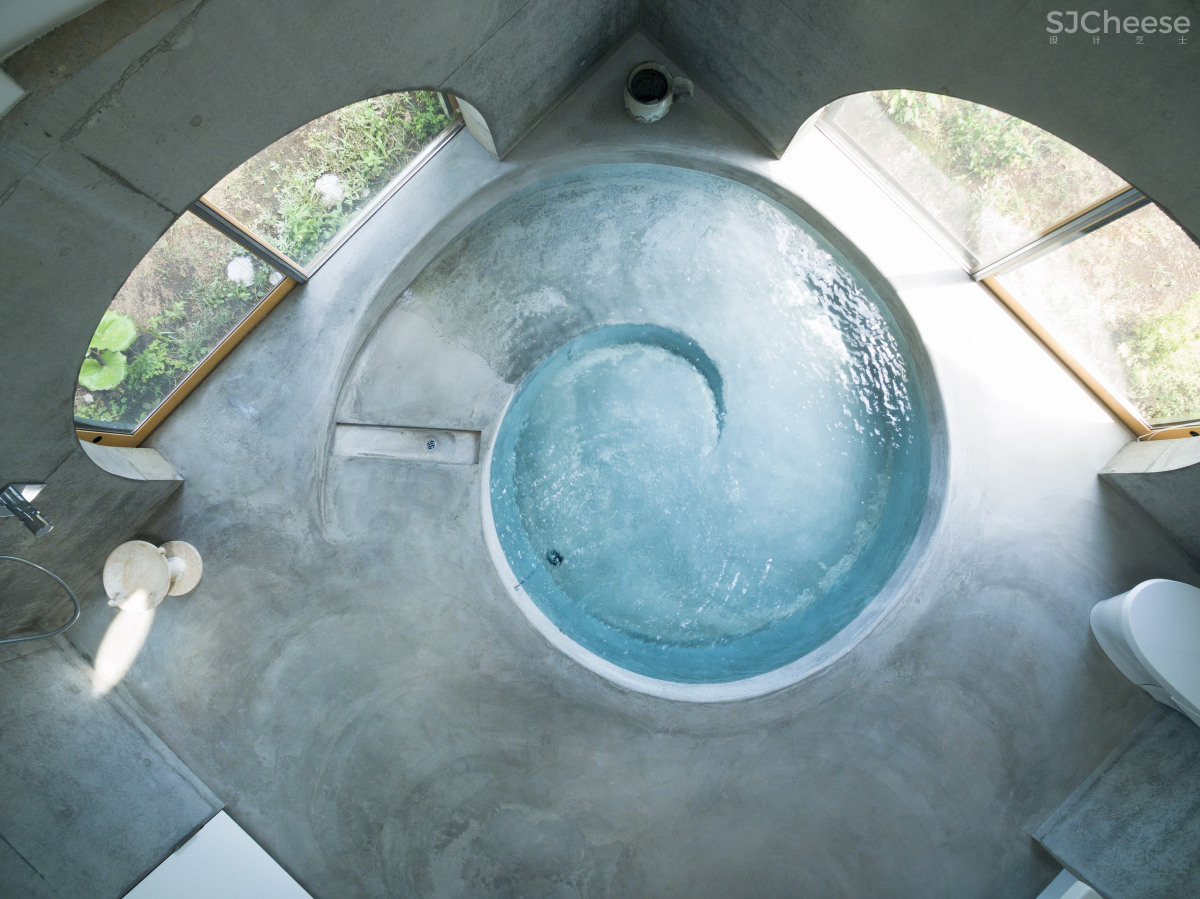 Teepee-shaped buildings by Issei Suma house community kitchen and pool