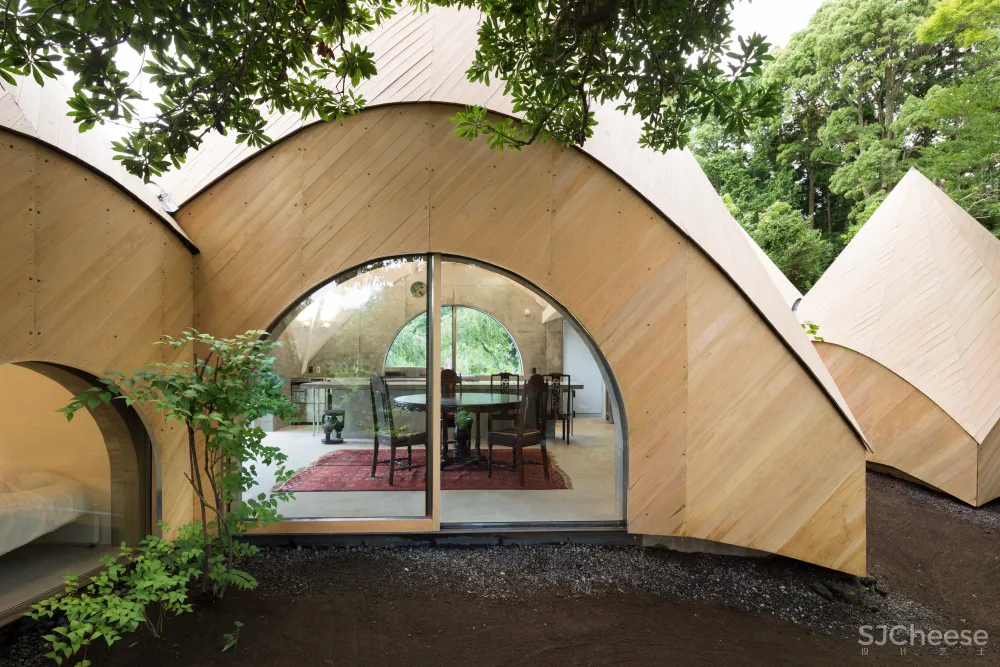 Teepee-shaped buildings by Issei Suma house community kitchen and pool