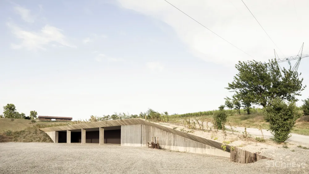 Deamicisarchitetti submerges concrete machinery depot into hillside