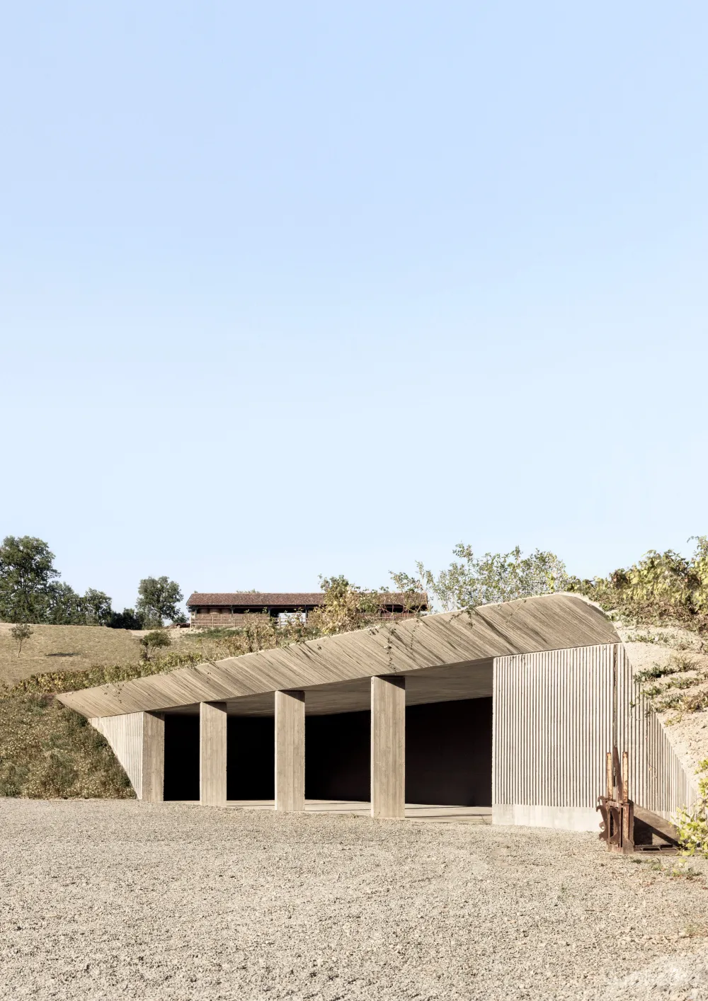 Deamicisarchitetti submerges concrete machinery depot into hillside