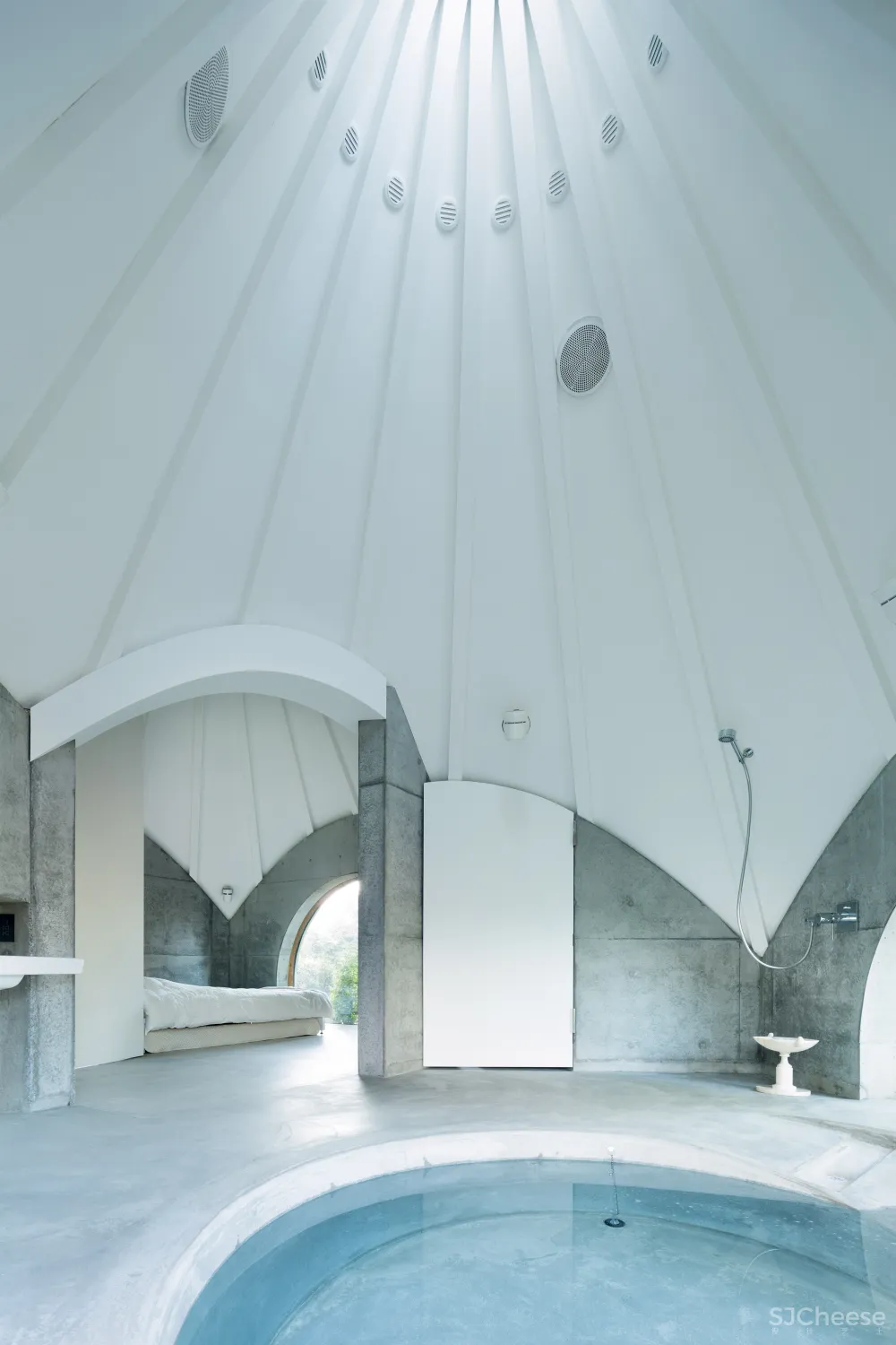 Teepee-shaped buildings by Issei Suma house community kitchen and pool